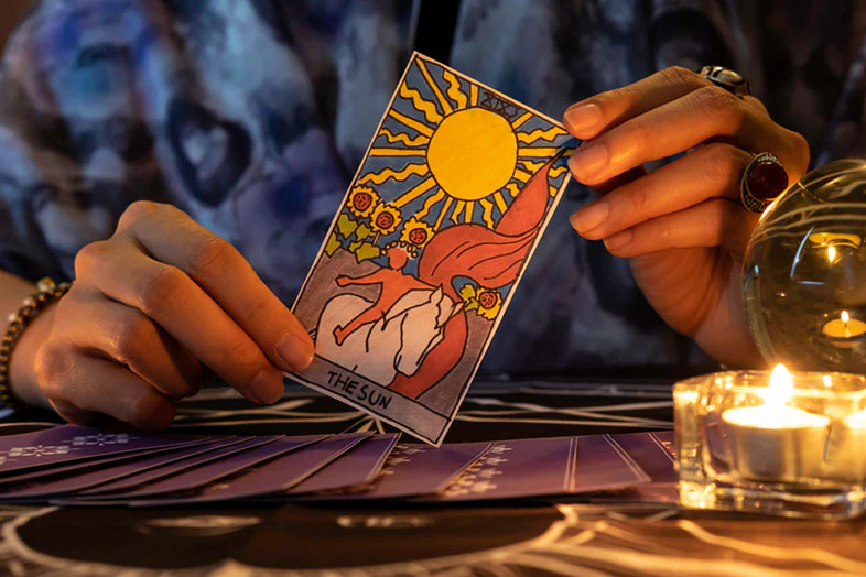 fortune teller hands holding sun card (1)
